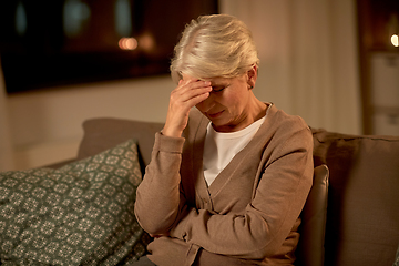 Image showing unhappy senior woman suffering from headache