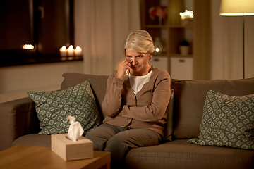 Image showing crying senior woman wiping tears with paper tissue