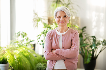 Image showing happy senior woman with cup of tea at home