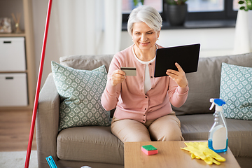 Image showing old woman with tablet pc and credit card at home