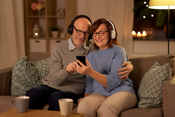Image showing senior couple with smartphone and headphones