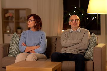 Image showing unhappy senior couple sitting on sofa at home