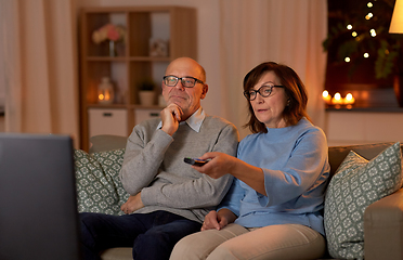 Image showing senior couple watching tv at home in evening