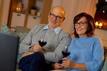 Image showing happy senior couple drink red wine and watch tv