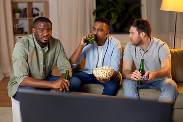 Image showing male friends with beer watching tv at home