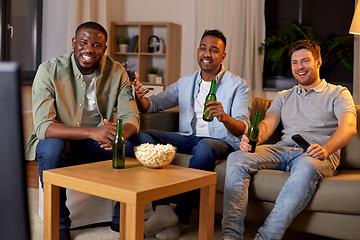 Image showing happy male friends with beer watching tv at home