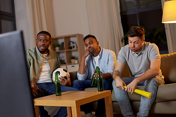 Image showing sad friends with beer watching soccer at home