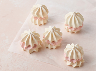 Image showing meringue cakes on pink background