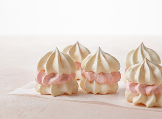 Image showing meringue cakes on pink background