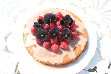Image showing Cake with raspberries and Pansies