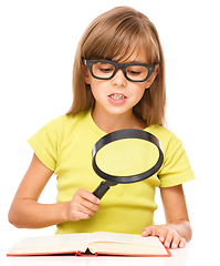 Image showing Little girl is reading book