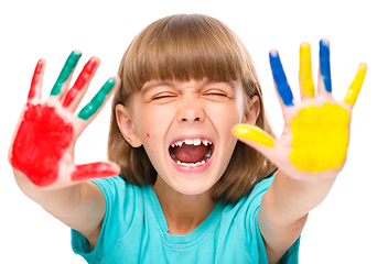 Image showing Portrait of a cute girl playing with paints