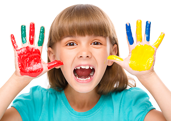 Image showing Portrait of a cute girl playing with paints