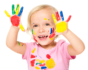 Image showing Portrait of a cute little girl playing with paints
