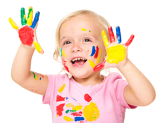 Image showing Portrait of a cute little girl playing with paints