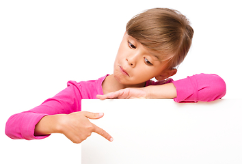 Image showing Little girl is looking out from the blank banner