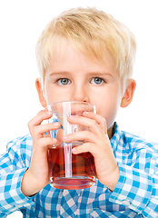 Image showing Little boy with glass of cherry juice