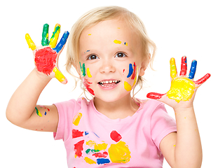 Image showing Portrait of a cute little girl playing with paints