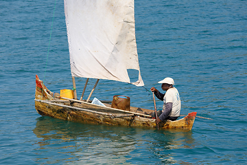 Image showing Malagasy man on sea in traditional handmade dugout wooden sailin