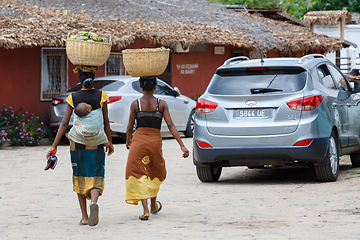 Image showing Malagasy women traditionally carry a basket of fruit on their he