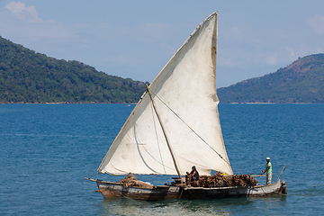 Image showing Malagasy man on sea in traditional handmade dugout wooden sailin