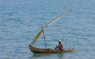 Image showing Malagasy man on sea in traditional handmade dugout wooden sailin