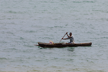 Image showing Malagasy man on sea in traditional handmade dugout wooden boat