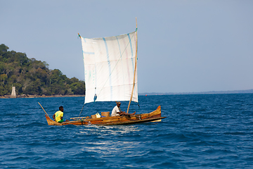 Image showing Malagasy man on sea in traditional handmade dugout wooden sailin