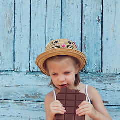 Image showing Girls eat chocolate