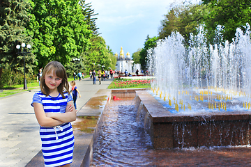 Image showing modern young girl has a rest in the city park with fountains