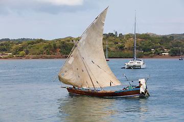 Image showing Malagasy man on sea in traditional handmade dugout wooden sailin