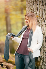 Image showing young woman standing in the fall forest