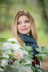 Image showing young woman standing in the green forest