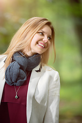 Image showing young woman standing in the green forest