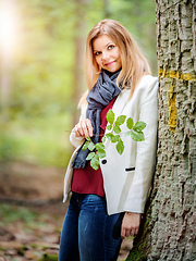 Image showing young woman standing in the green forest