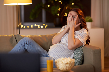 Image showing scared pregnant woman watching tv at home