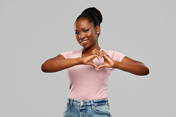 Image showing african american woman making hand heart gesture