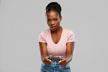 Image showing african american woman with gamepad playig game