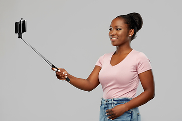 Image showing african american woman taking selfie by smartphone