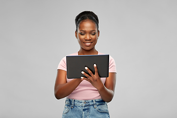 Image showing happy african american woman using tablet pc