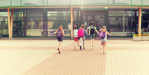 Image showing group of happy elementary school students running