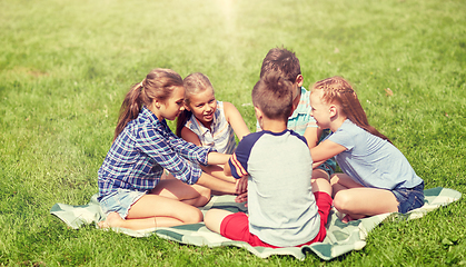 Image showing group of happy kids putting hands together