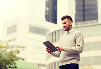 Image showing happy man with tablet pc computer in city