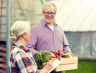 Image showing senior couple with box of vegetables on farm