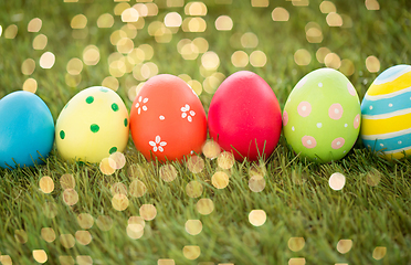 Image showing row of colored easter eggs on artificial grass