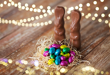 Image showing easter eggs in straw nest and chocolate bunnies