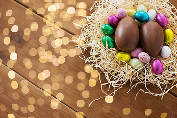 Image showing chocolate eggs and candies in straw nest