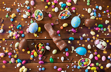 Image showing chocolate eggs, easter bunny and candies on wood