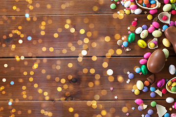 Image showing chocolate eggs and candy drops on wooden table