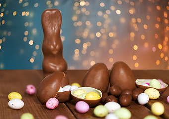 Image showing chocolate eggs, easter bunny and candies on wood